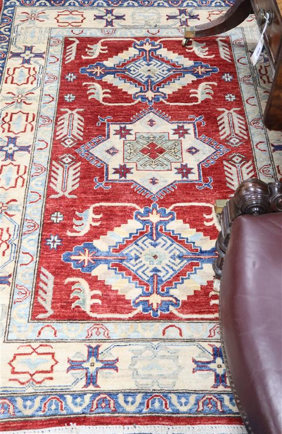 A Turkish Caucasian design brick red ground rug, 180 x 120cm